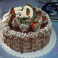 50Th Birthday Cake I made this cake for my uncle's birthday. It was a three-layer chocolate cake (soaked in a strawberry syrup) filled with a dark...