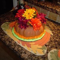 Thanksgiving I made this cake for work. All fondant and flowers are artificial. The cake is yelloww cake made from a bunt pan.
