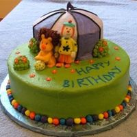 Jo Jo's Circus Cake is 10" and 6" with the top carved into a tent. Cakes are iced in BC and all decorations are in fondant. I painted the...