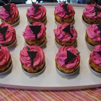 Martini Cupcakes Yellow cake w/ micro choc chips, iced in amaretto flavored buttercream. Gumpaste martini glasses and olives. Done for a bachelorette party...