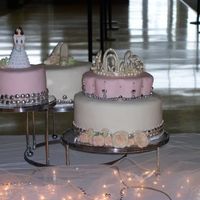 La Quniceneara Three tier cake. Decorated with imported chocolate heart shaped dragees and edible pink/silver pearls. One layer chocolate fudge with...