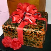 Leopard Gift This is an airbrushed Leopard gift with a gumpaste red betty loop bow.