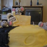 Cheesie Cake-Dif. Angle The cake is chocolate cake with rasberry filling. Frosting is buttercream. Figures from fondant.