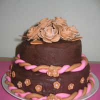 First Fondant Flowers-Anniversary Cake For In Laws Chocolate cake from scratch with chocolate ganache filling. Buttercream frosting and everything else is Fondant.