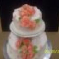 Wilton Course Iii Final This is a white cake with white buttercream icing. The roses are fondant. The drop flowers are royal icing.