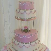 4 Tier Heart Semi stacked heart shaped wedding cake with crystal pillars.