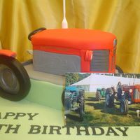 Vintage Tractor Red vintage tractor carved from rich fruit cake, a replica of one owned by the birthday boy
