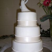 Another Simple Wedding Cake This one is almost identical to the last wedding cake I made, but this time I got paid for it - yay! Very simple fondant with ribbon and...