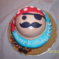 Pirate Cake BC cake with fondant accents and gold chocolate coins at the base of cake.