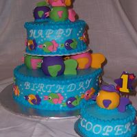 1St Birthday / Fish Cake 2 tiered BC cake and birthday girl's smash cake with Fondant accents. I had fun making this one! Thanks for looking.