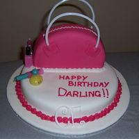 Handbag Cake devils food cake covered in choc bc and then mmf, handles are plastic and nail polish, lipstick, perfume and mascara are all candles