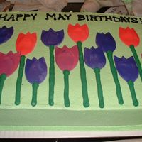 Tulip Birthday Cake This was done with fondant and a crescent shaped cutter for the petals The icing was buttercream on a white cake.