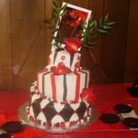 Red, White, And Black Whimsical This was my first whimsical cake. It was for my nephew's graduation party..he wanted an Asian theme, so his picture is held up with...