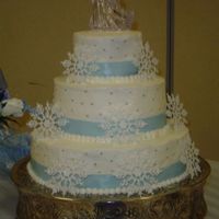 Snowflake White cake with buttercream frosting, silver candy dots, wish I could take credit for the snowflakes, but they are plastic.