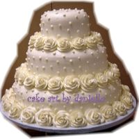 Ring Of Roses all white cake. swiss dots with roses around the bottom of each cake.