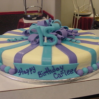 Carlee Brownie on inside, covered in buttercream with fondat accents.