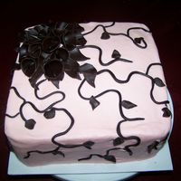 Calla Lillies Cake frosted in pale pink with chocolate calla lillies and vines