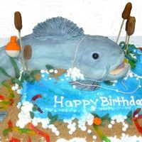 Catfish Birthday Cake My husband asked for a catfish birthday cake. Everything is edible except the skewers in the catails and the string on the bobber.