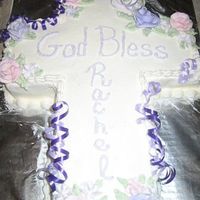 Cross Baptism Cake I recently made this cake for a friend's daughter's baptism. It's a cross cake with purple ribbon and flowers.