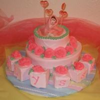 Sweet Heart Baby Cake 2 tier cake with pink roses and blocks spell out ALYSSA. The baby topper is all fondant.