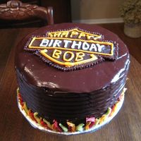 Harley Davidson Birthday Cake Thanks for all of the inspiration on this website! Chocolate ganache frosting, and used stencil for harley logo and filled in with melted...