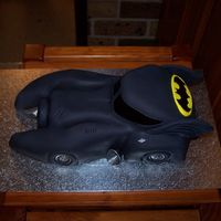 The Batmobile I made this for my sons 5th birthday.10inch round chocolate mudcake cut and carved to look like the batmobile then covered in black fondant...