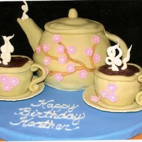 Tea Pot Tea pot is made with the sports ball pan, cups are cup cakes. Covered in fondant with fondant flowers and white chocolate "steam&quot...