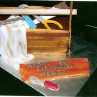 Tool Box Cake was made with a 9" X 13" pan, cut in thirds and layered. Sides of the box are sugar cookies, cut to shape, imprinted with a...