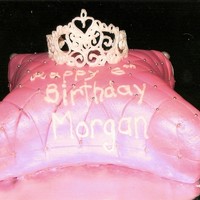 Pillow Cake cake cut to shape, covered in fondant, scored to make pattern, silver dragees at corners. The crown is made out of royal icing the pattern...