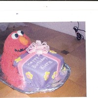 Elmo Present is cake covered in fondant with fondant bow. Elmo is RKT covered in red buttercream pulled out using the multi hole tip (sore hand...
