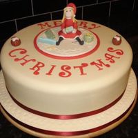 Santa's Little Helper This cake weights 9kg, its a 12" fruit cake covered with marzipan and sugarpaste. The girl is also all edible, and made with modelling...