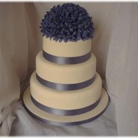 Blue Wedding Cake Ivory Fondant covered cake with silk flowers and matching satin ribbon