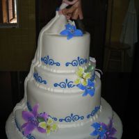 Kissing Couple Cake My 3rd wedding cake and one of my first fondant covered cakes. Have gotten the hang of covering the large cakes now. The drape on the side...