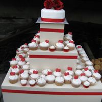 Lisa's Wedding french vanilla cake and cupcakes - cake covered in fondant with silk roses on top - red chocolate hearts on the cupcakes - bride wanted a...