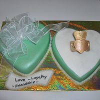 Claddagh Ring Made this for an irish wedding shower. Heart pan with fondant. The ring is Gum paste with gold luster dust. I couldn't make a bow out...