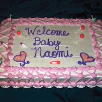 Bottles & Storks Cake This 11x15 coconut vanilla cake was iced in buttercream with latice work and reverse shell borders and accented with plastic baby items.