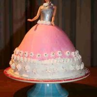 Birthday Princess Yellow cake with icing on lower cake, with cheese-marmelade filling. Doll cake is covered with buttercream and MMF. Flowers are from icing...