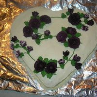 Purple Roses I used a round cake and a square cake and then formed the heart. I thought the purple roses were different and actually kinda liked them....