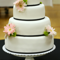 4 Tier Daisy Wedding Cake 4 tier (6-9-12-14) white fondant wedding cake decorated with black grossgrain ribbon and fresh pale pink gerber daisies. I couldn't...