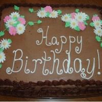 Chocolate Buttercream Birthday Cake This was done for my grandparents birthdays, which are 4 days apart. It was pound cake with chocolate buttercream with royal icing flowers...