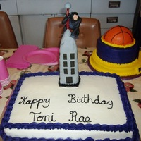 King Kong Wannabe For a awo year girl who loves King Kong. Couldn't find King Kong in stores so used a gorilla. Building is fondant covered cereal treat...