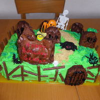 Graveyard Birthday Cake Graveyards are make from brownies, sugarpaste insects, and plastic bats and skeleton.