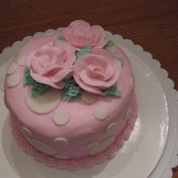 Pink & Dot Bday Cake 5 inch/2 layer white chocolate cake, BC icing and roses with fondant dots. Made for a 1st birthday girl!!