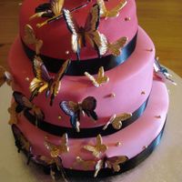 Pink Butterfly Cake Chocolate, Carrot and Vanilla tiered cake. Made butterflies out of flower paste and painted them with edable paint and shimmer dust. It...
