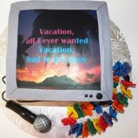 Karaoke Night Edible image screen - mic in fondant. Hawaiin necklace is fondant flowers strung on a piece of licorice.