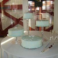 Snowflake Wedding Cake Light blue buttercream icing with fondant snowflakes. Each one on a clear column and tier.