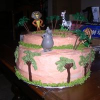 Madagascar Themed Cake This was done for a 3 year old who loved Madagascar! It is all buttercream with cake topper figurines!
