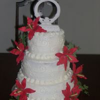 My 1St Wedding Cake This was my first wedding cake the bride wanted white and simple with the red lilies... I ordered the lilies online since there was no time...