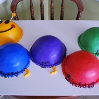 Baby Einstein Caterpillar I used the half ball pan for the humps. The facial features are chocolate and the antenna are lollipops.