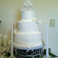 My 1St "real" Wedding Cake This was my first real wedding cake. I made it for my cousin's wedding. All white cake, iced in BC, w/ BC scrollwork and fondant calla...